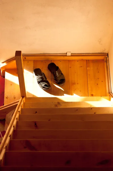 stock image A pair of slippers on stairs in morning light