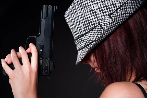 Girl in hat with a big pistol — Stock Photo, Image