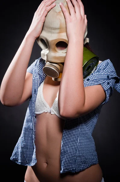 Girl in gasmask holding her head — Stock Photo, Image