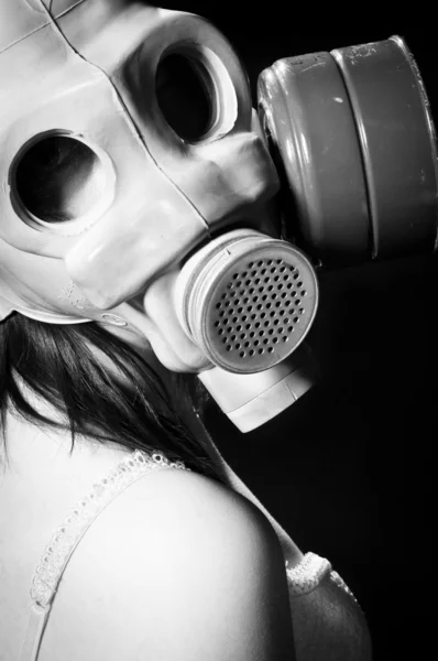 Girl wearing gasmask and white lingerie holding her head — Stock Photo, Image