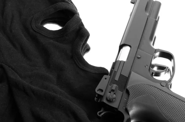Pistol and mask of a thief over white — Stock Photo, Image