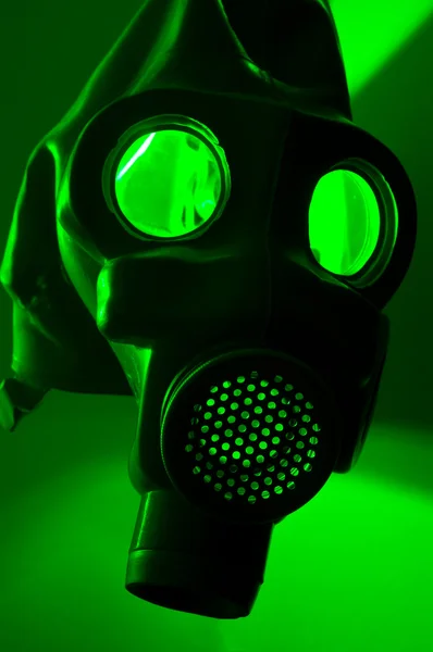 A military gasmask in green light — Stockfoto