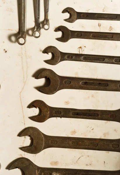 Many spanners on white board — Stock Photo, Image