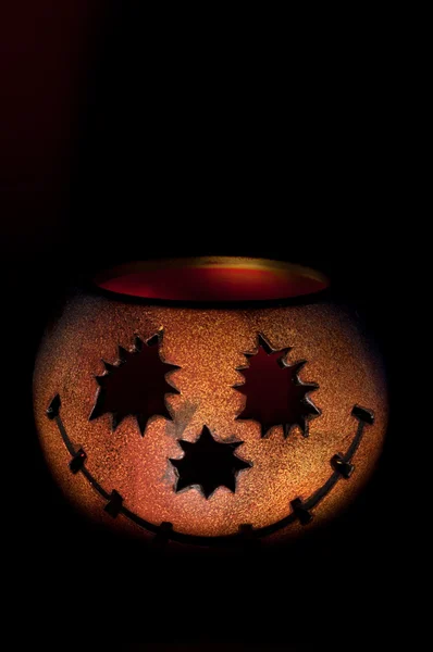 Pumkin shaped candle holder against dark background — Stock Photo, Image