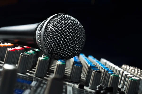 Part of an audio sound mixer with a microphone — Stock Photo, Image