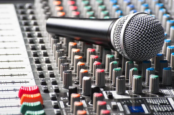 Part of an audio sound mixer with a microphone — Stock Photo, Image