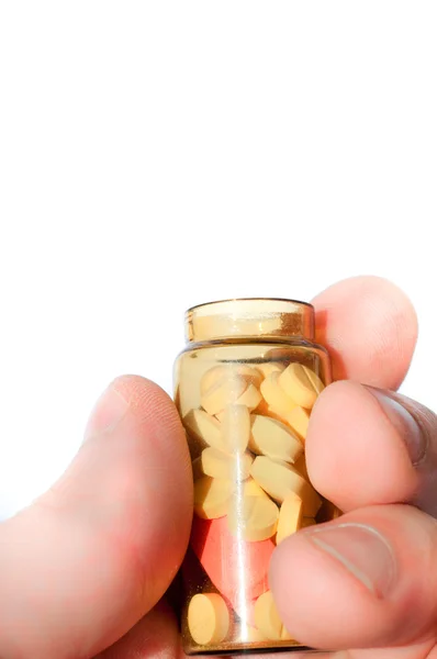 Kezében gyógyszer palackot teljes tabletták — Stock Fotó
