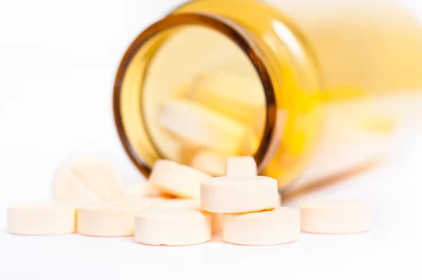 Pills with bottle on isolated white background — Stock Photo, Image