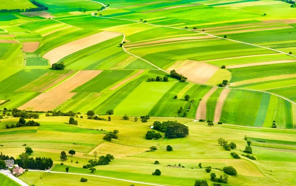 Aerial view of green fields and slopes — Stock Photo, Image