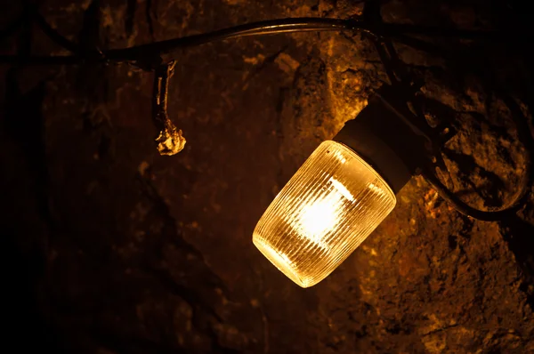 Old electric light in cavern — Stock Photo, Image