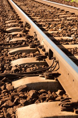 Close up shot of a rusty rails with wires attached to them clipart