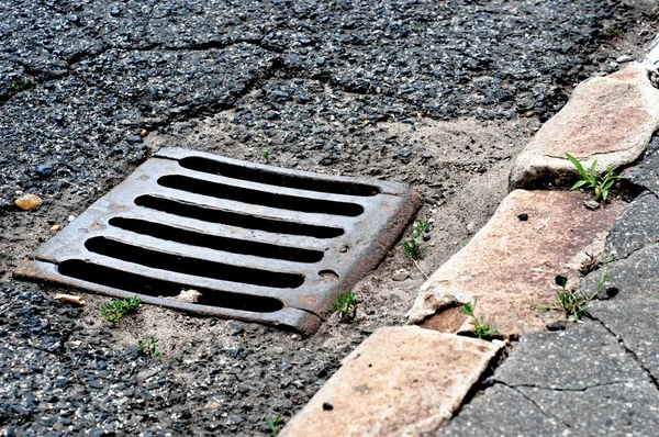 Sewer drain on road — Stock Photo, Image