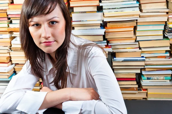 Beautiful young student girl in library — Stock Photo, Image