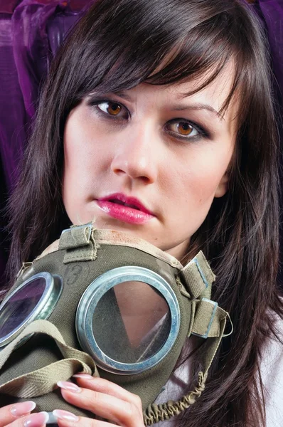 Portrait of a young woman holding her gasmask tight — Stock Photo, Image