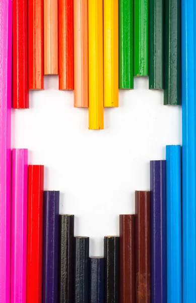 Colored pencils in heart shape on white — Stock Photo, Image
