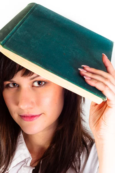 Jong meisje en haar boek tegen witte achtergrond — Stockfoto
