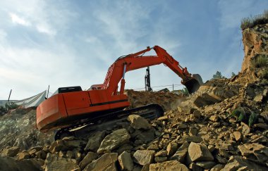 Excavator crushing rocks clipart