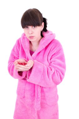 The young woman in a dressing gown holds a handful of tablets clipart