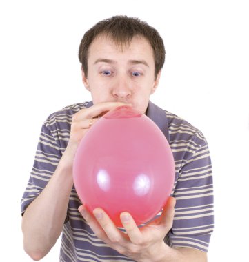 The young man inflates a red balloon clipart