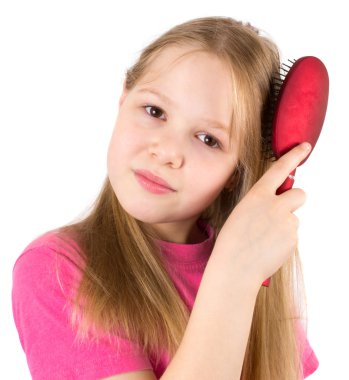 The beautiful girl brushes hair with a hairbrush clipart