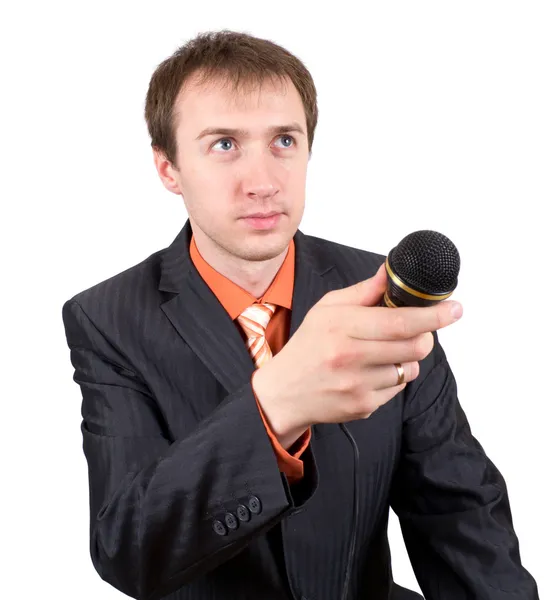 stock image The young man with a microphone interviews