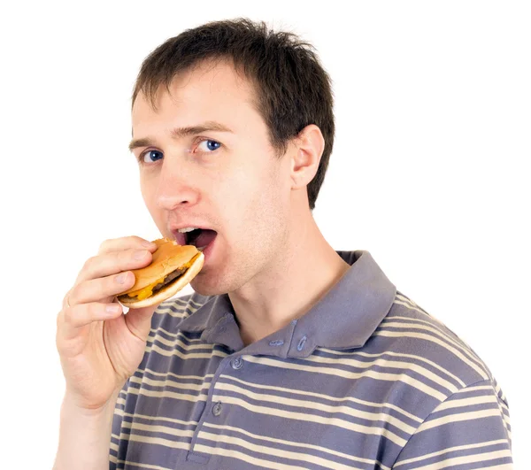 stock image The young man is appetizing eats a hamburger