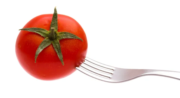 stock image Red tomato on a plug isolated on the white