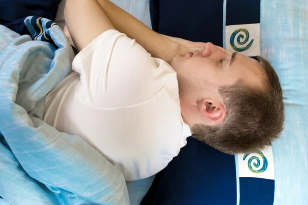 stock image Man comfortably sleeping in his bed