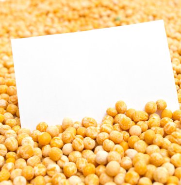 Dried yellow peas with a blank card clipart