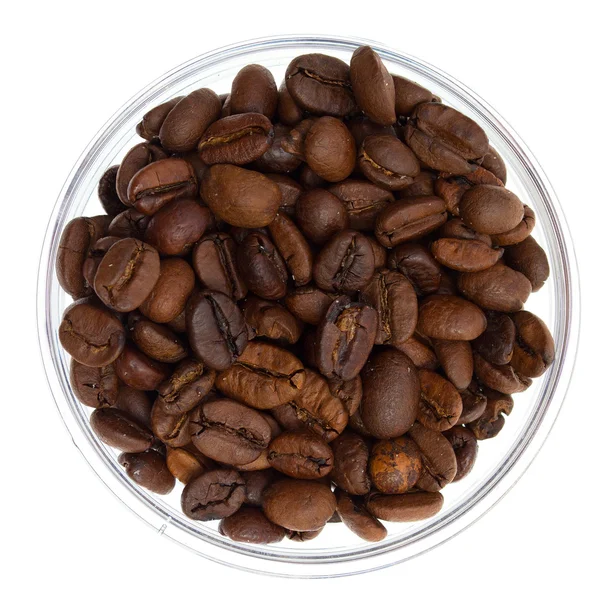 stock image Natural coffee beans heap in transparent glass bowl, isolated on