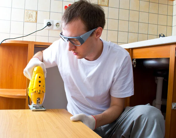 stock image The man with an electrofret saw