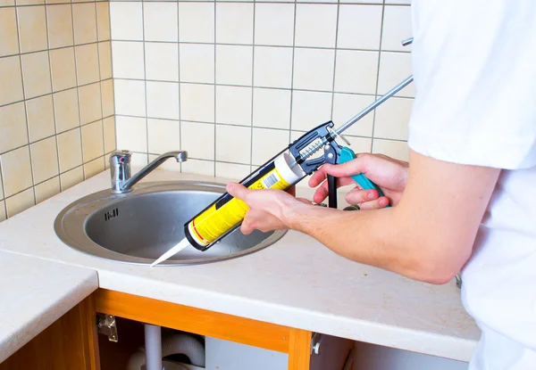 stock image Caulking gun putting silicone sealant to installing a kitchen si