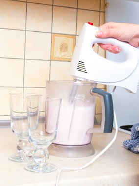 Hand with mixer making a milkshake
