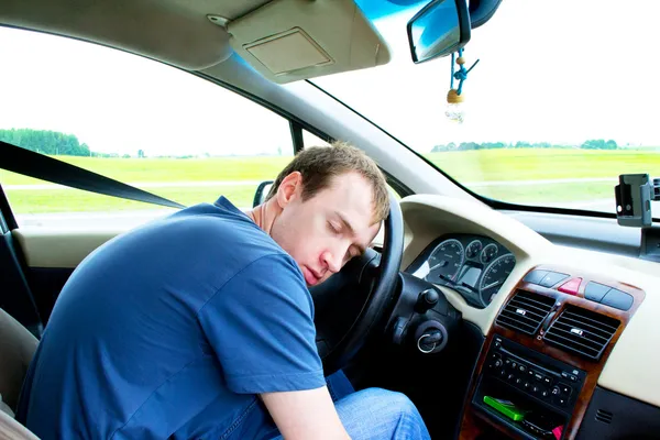 stock image Man sleeps in a car