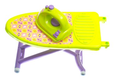 Toy iron and ironing board on white clipart