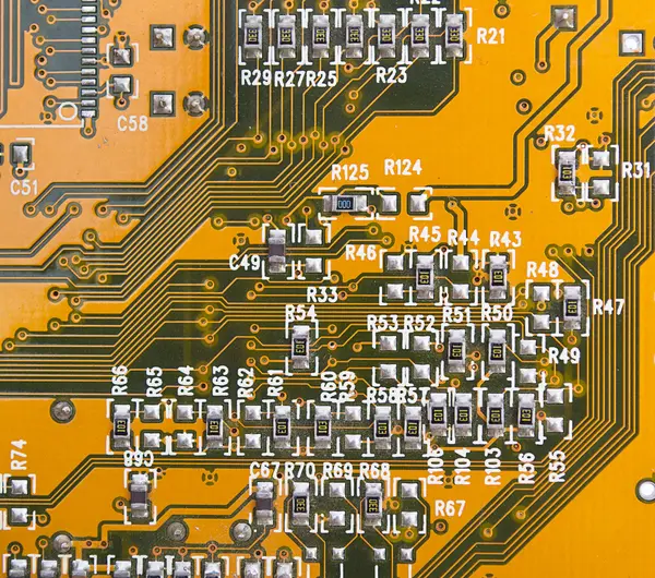 stock image Yellow circuit board with components.