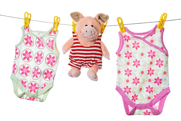 stock image Baby sleepers and pig on the clothesline, studio isolated on whi