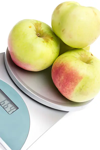 stock image Apples on the scales on a white