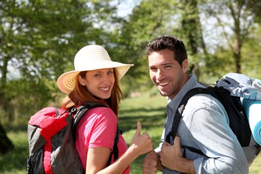 Happy couple on a hiking day clipart