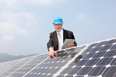 Businessman checking photovoltaic installation clipart