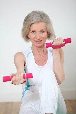 Senior woman doing yoga exercises clipart