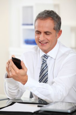 Portrait of businessman using mobile phone clipart