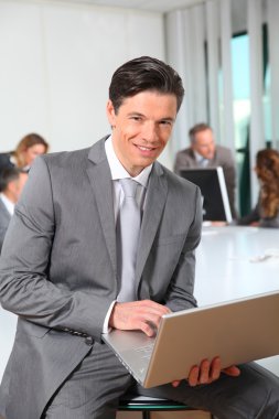 Businessman working on laptop compute clipart