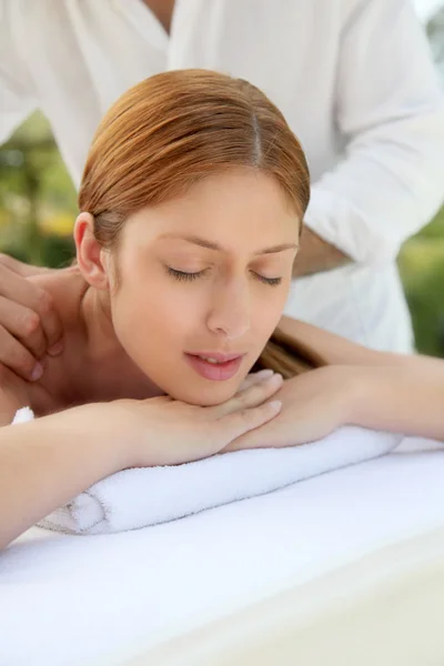 Beautiful woman laying on a massage bed — Stock Photo, Image