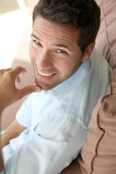 Portrait of handsome man sitting in sofa — Stock Photo, Image