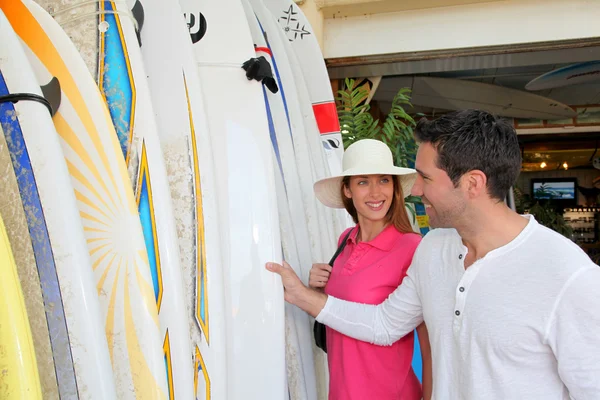 Couple standing on a surfshop — Stock Photo, Image
