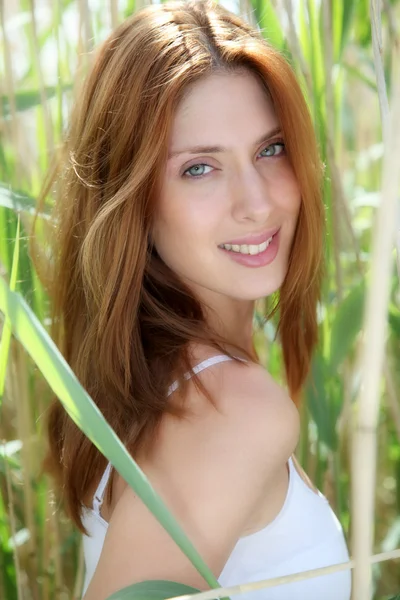 Portrait of beautiful woman in reeds field — Stock Photo, Image