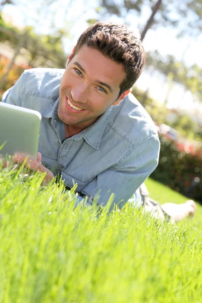Man with electronic tablet in public park — Stock Photo, Image