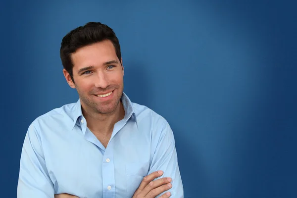 Porträt eines gutaussehenden Mannes auf blauem Hintergrund — Stockfoto