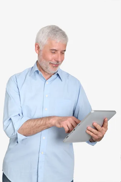 Uomo anziano utilizzando tablet elettronico — Foto Stock